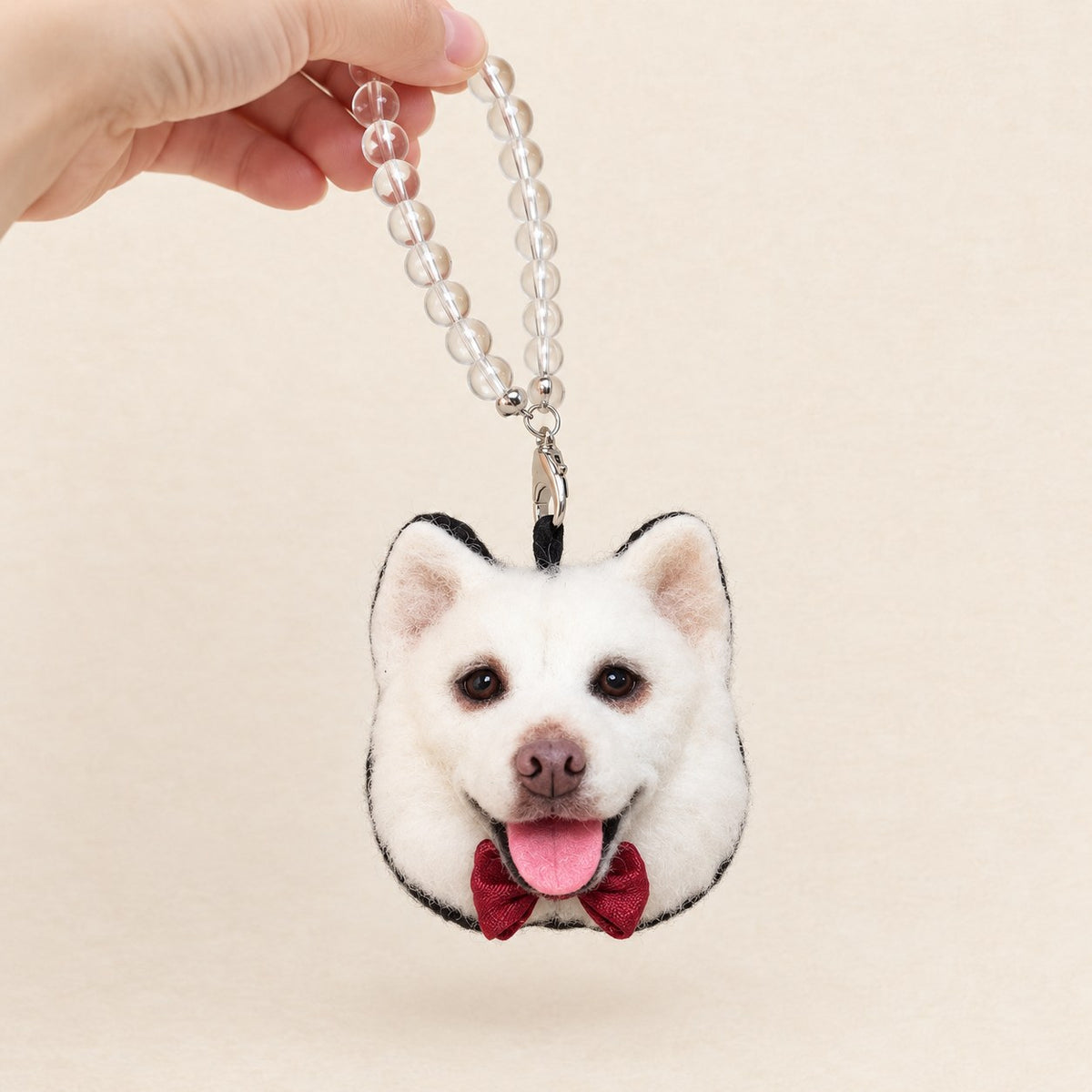 Handmade wool-felt white dog charm front view on a beaded strap