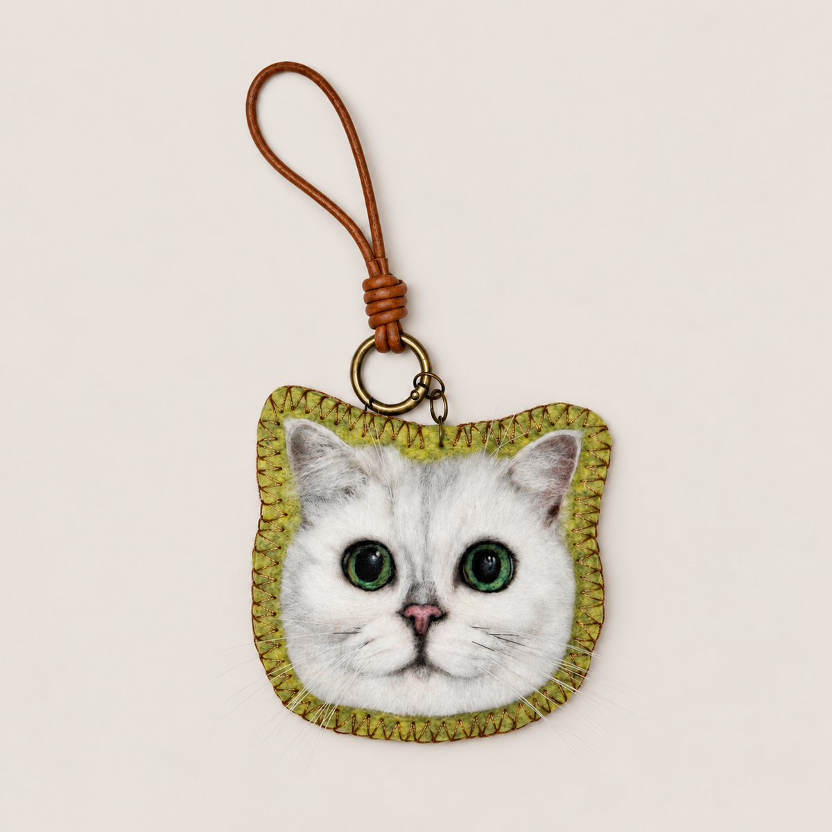 Handmade wool-felt white cat charm with strap, front view