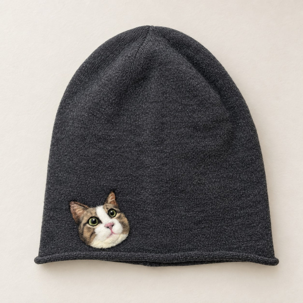 Custom wool-felt pet portrait hat flat lay